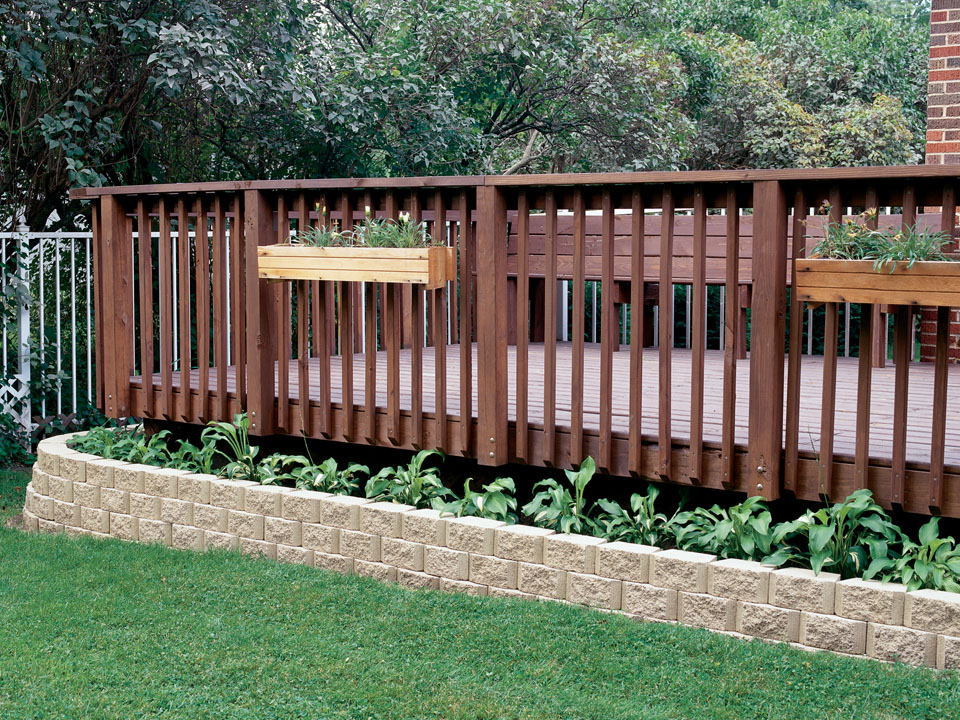 Wooden porch with planter border made of Border Stone concrete block retaining walls