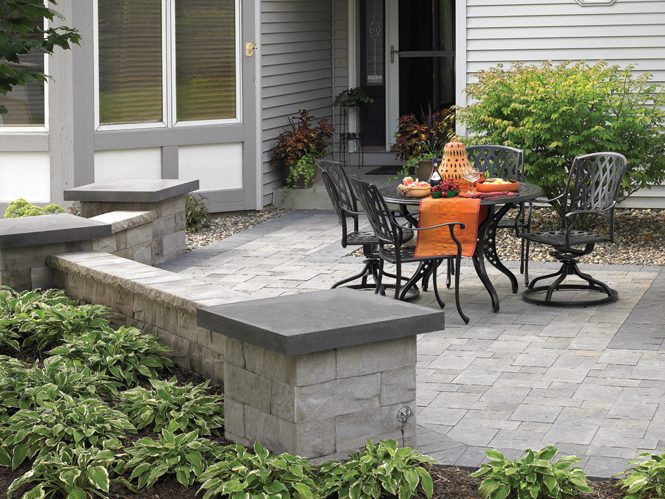Gray stone paver patio with angled Brisa freestanding concrete block walls 