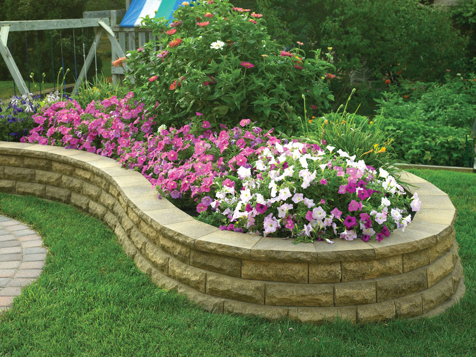 Close view of curved raised planting area made with ChiselWall concrete block retaining walls