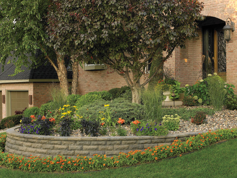 Curved raised planting area made with ChiselWall concrete block retaining walls