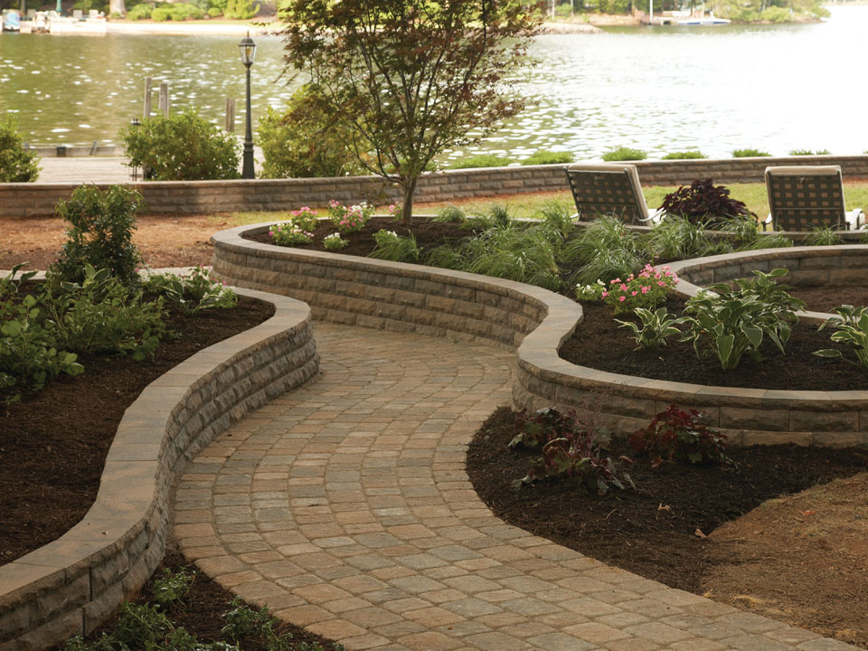 Lakeside abstract raised planters made with ChiselWall retaining walls flanking a paver stone walkway