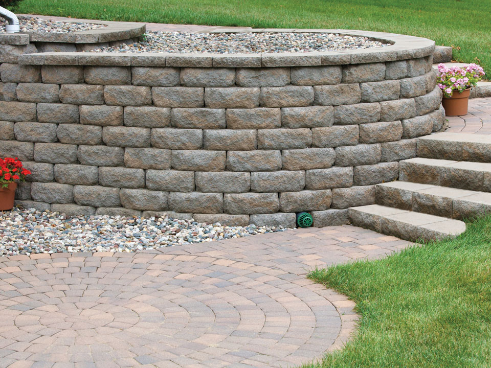 Circular paver patio with stone stairs and raised Diamond Pro stone cut casual face retaining wall