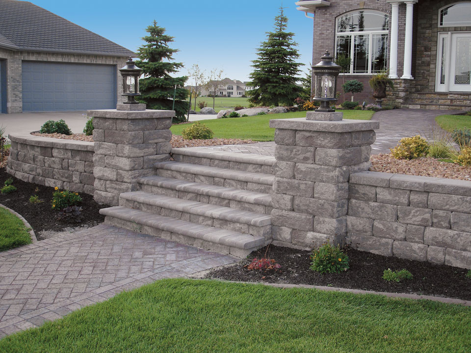 Paver walkway and raised planting areas made from Highland Stone concrete block retaining walls with inset stairway
