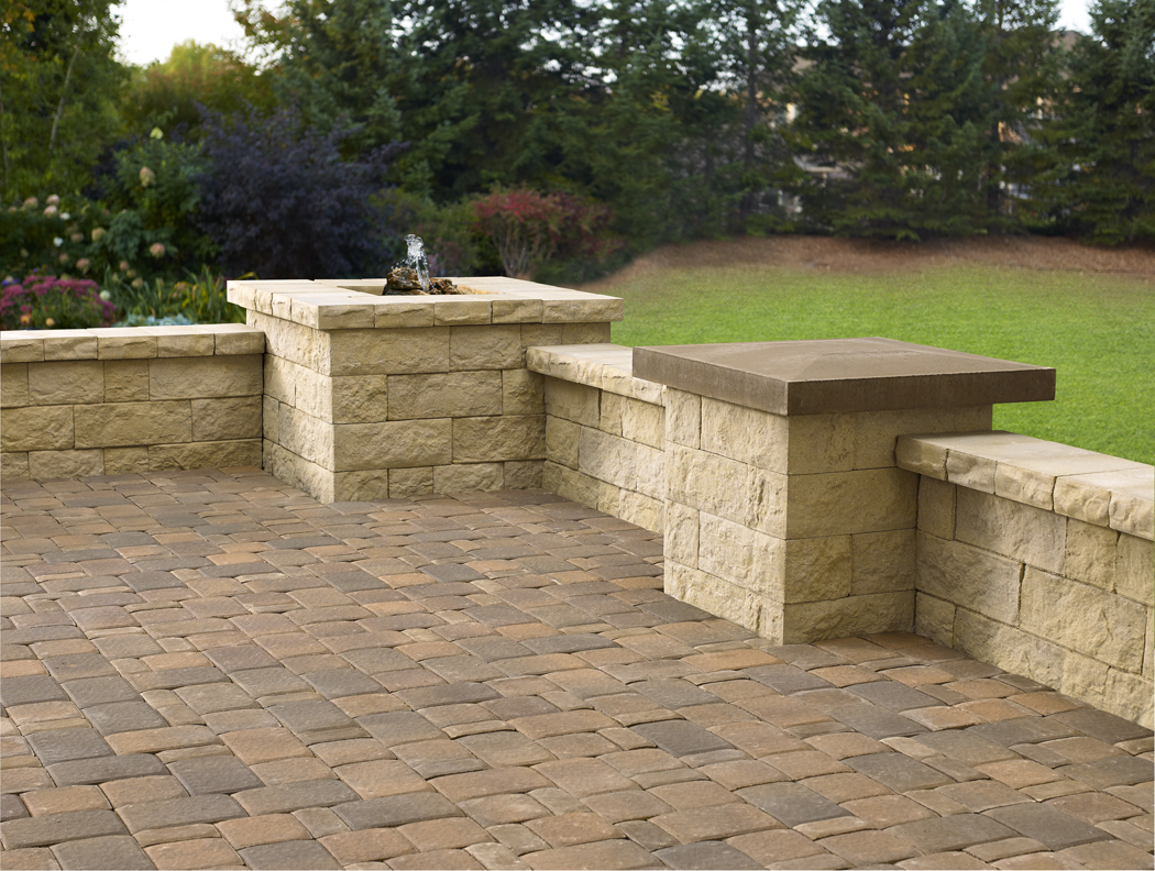 Paver patio corner and Matiz concrete block freestanding walls and columns with a built in water feature. 
